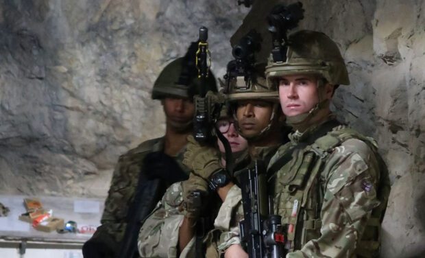 Members of the Royal Gibraltar Regiment stand armed in the tunnels beneath Gibraltar