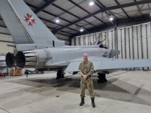 airman in front of a jet