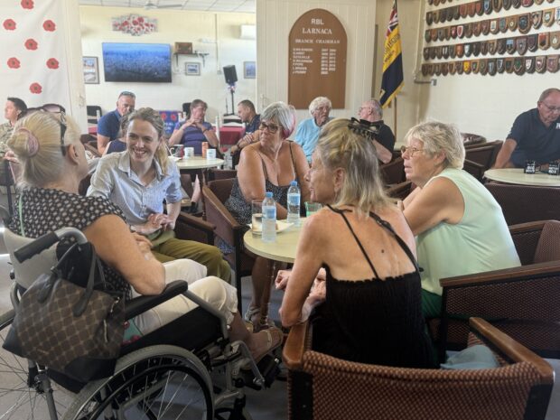 The minister talking with some women around a table