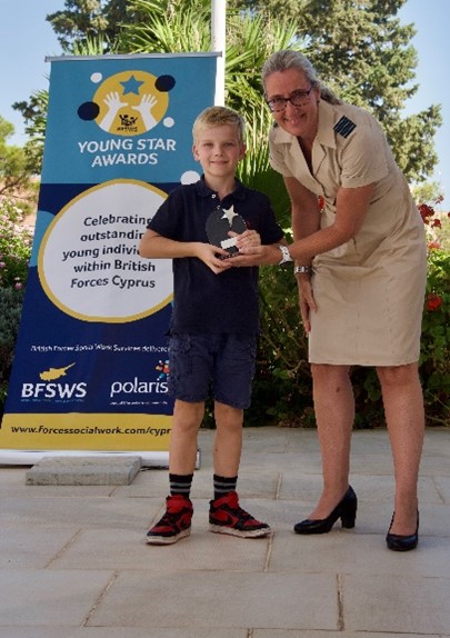 a child with a woman in uniform