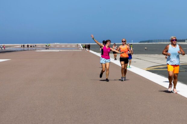 People running down the Gibraltar runway