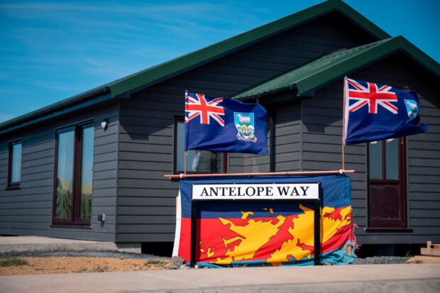 street sign saying Antelope Way outside a wooden building